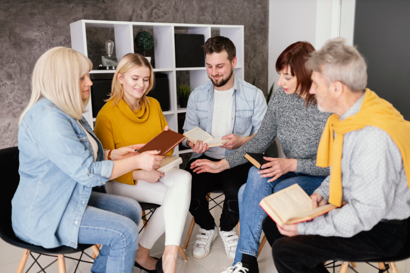 group-people-reading-books-therapy-session